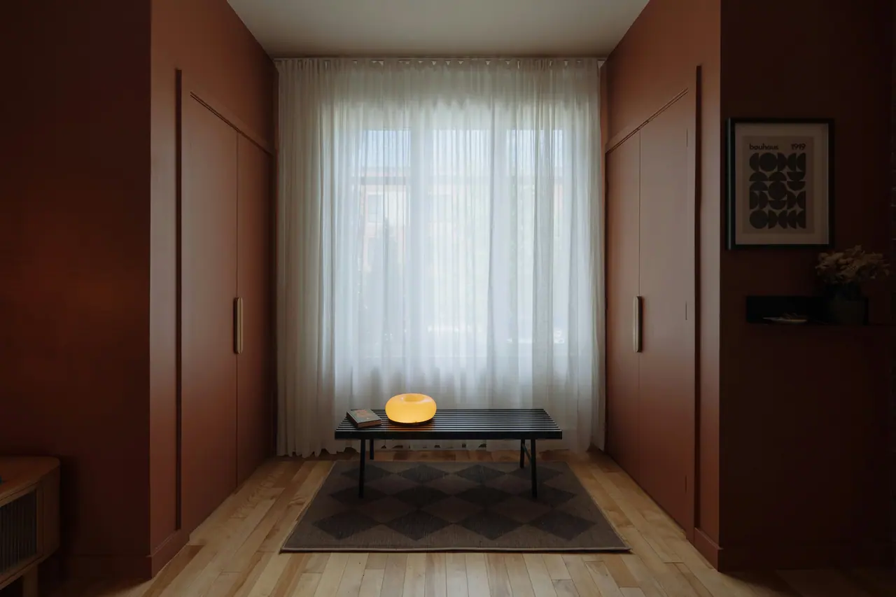 Walnut-paneled hallway with sheer curtains
