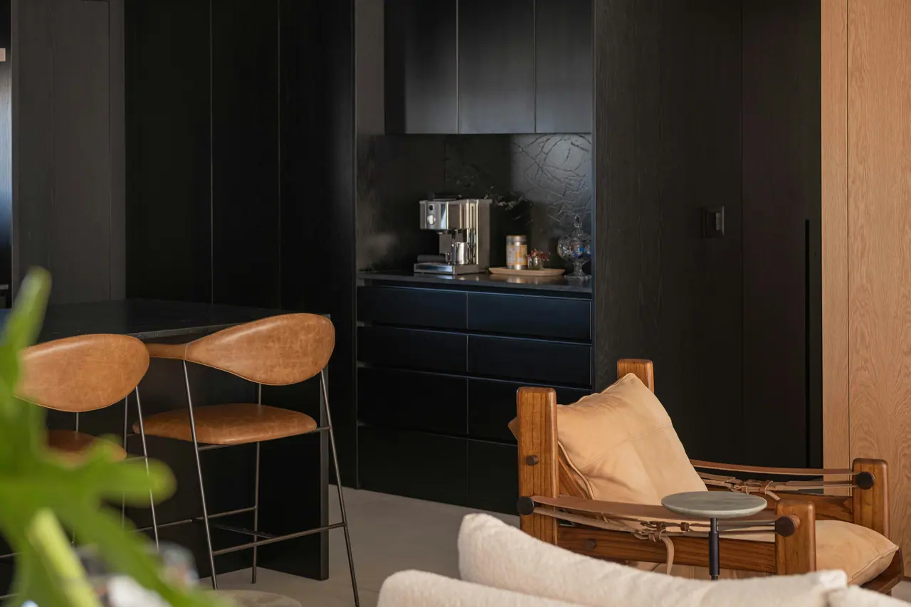 Dark kitchen with leather bar stools