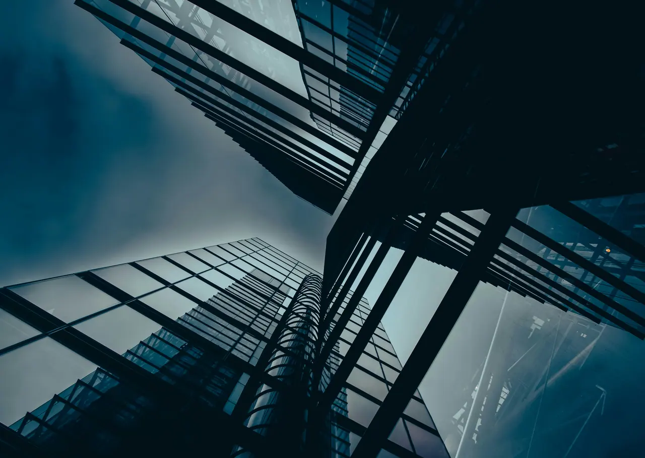 Looking up at glass office towers converging into the sky