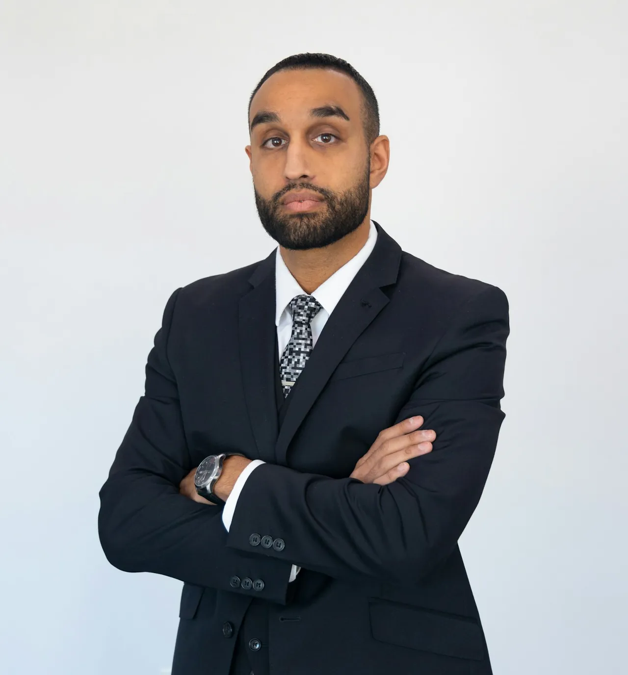 Portrait of an attorney in a dark suit, arms folded