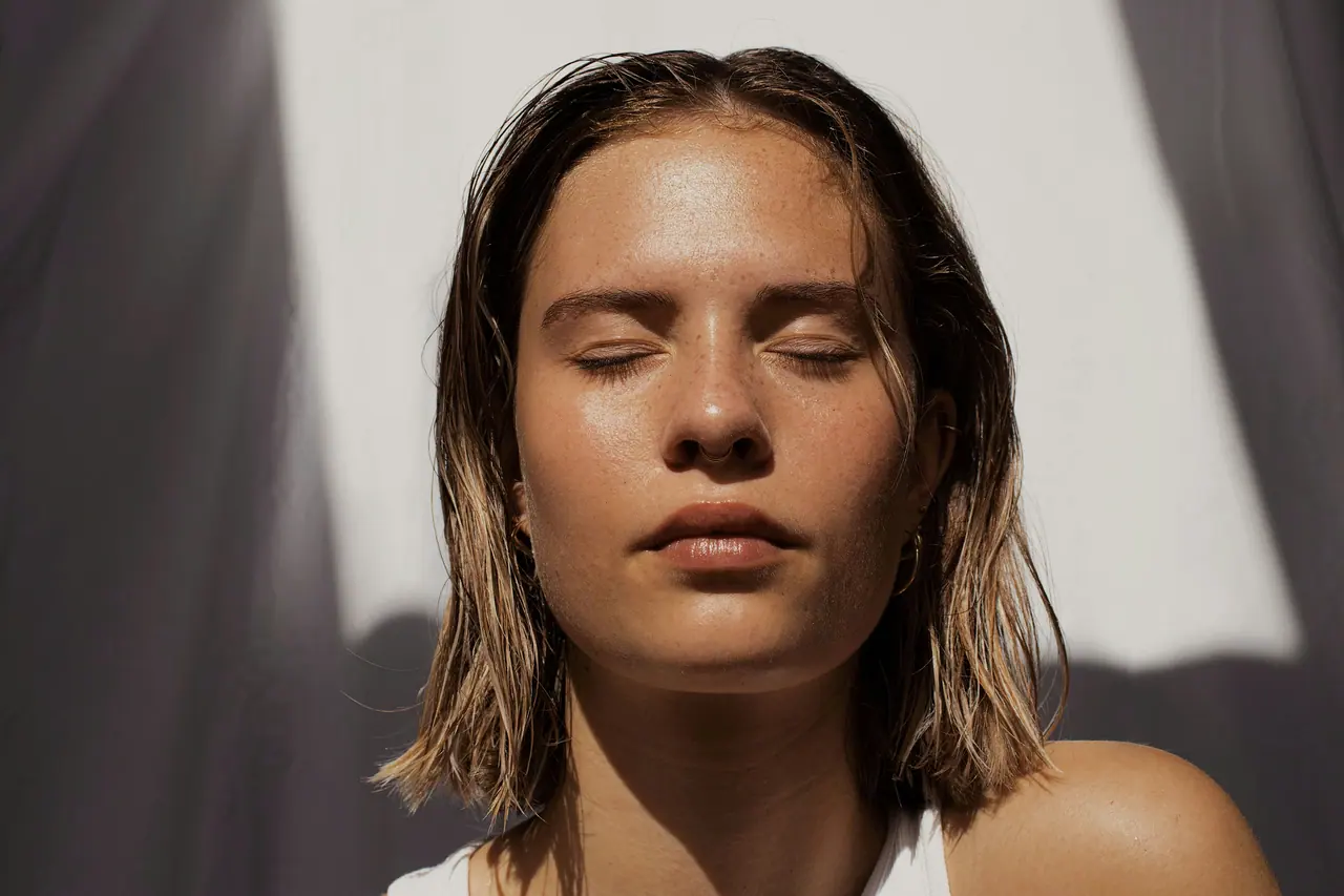 A woman with closed eyes in soft natural light