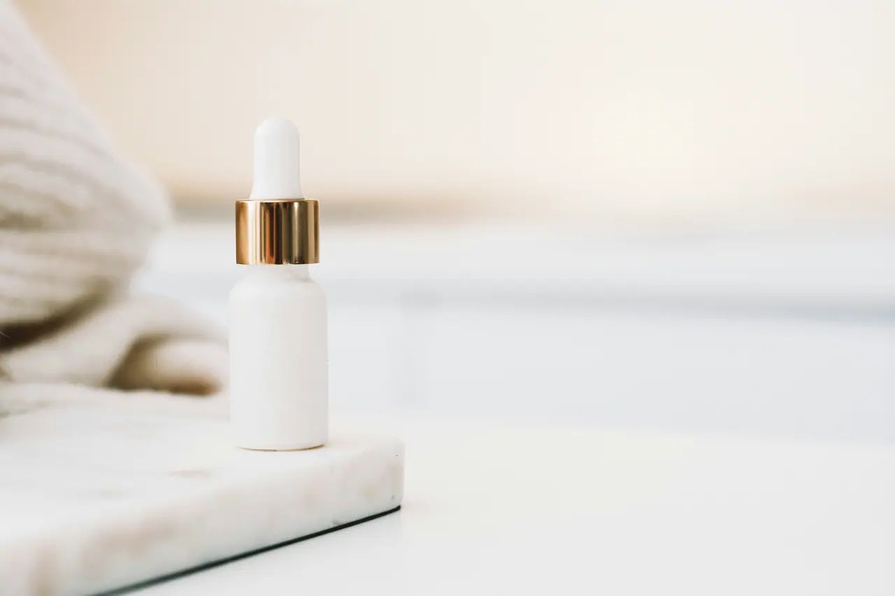 White dropper bottle on a marble block