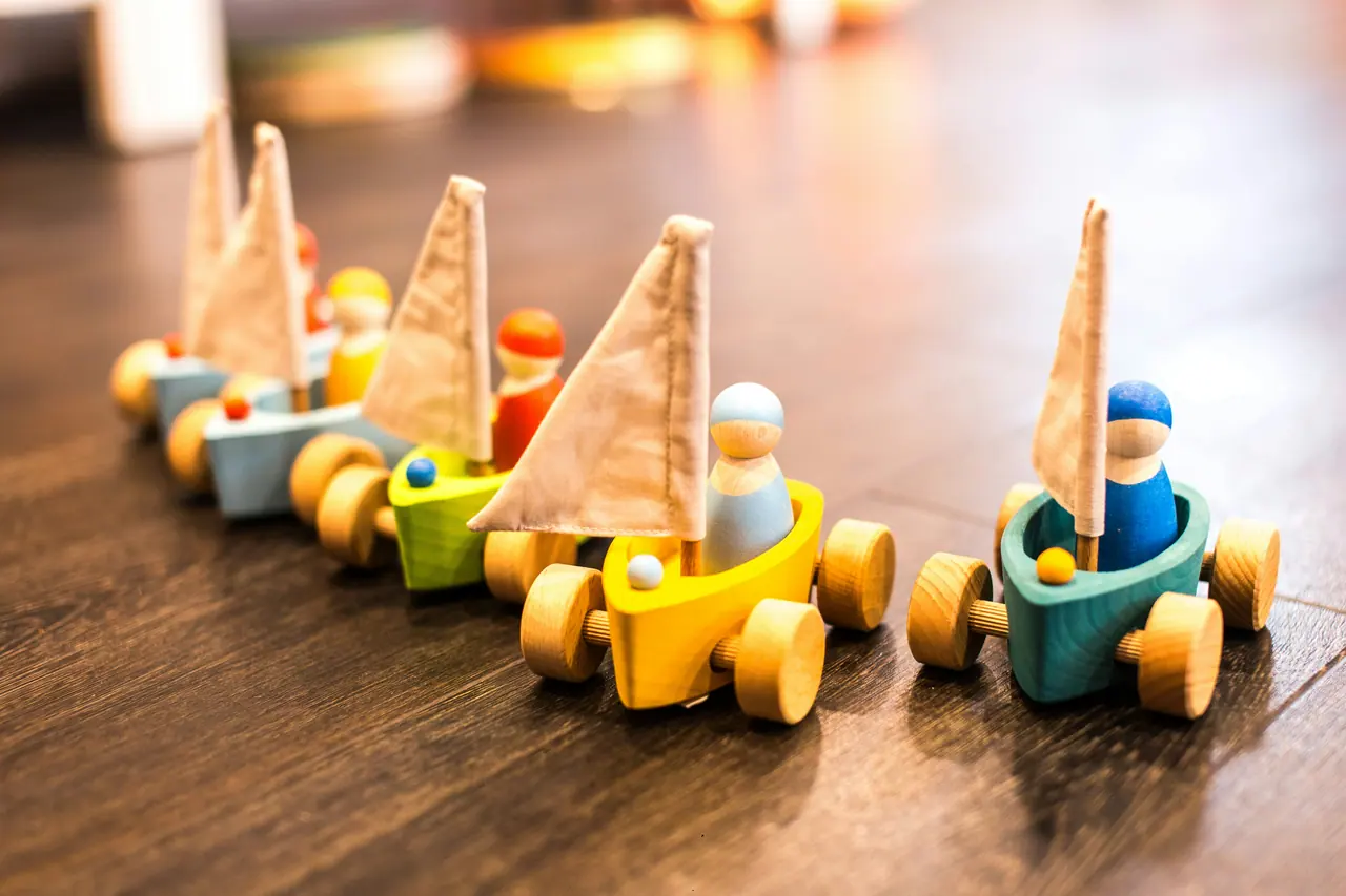 Handmade wooden toy boats lined up