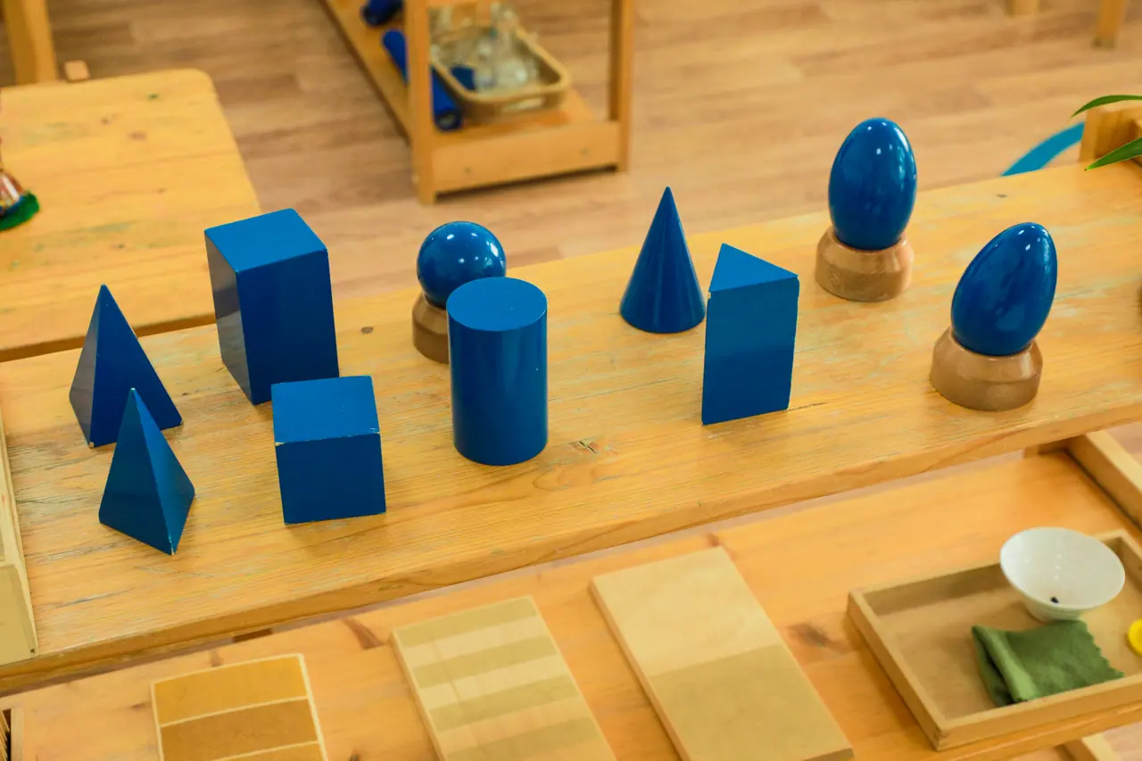 Blue geometric solids on a wooden tray