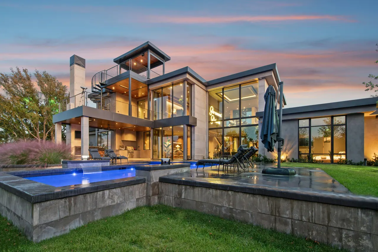 Modern residence with infinity pools at dusk