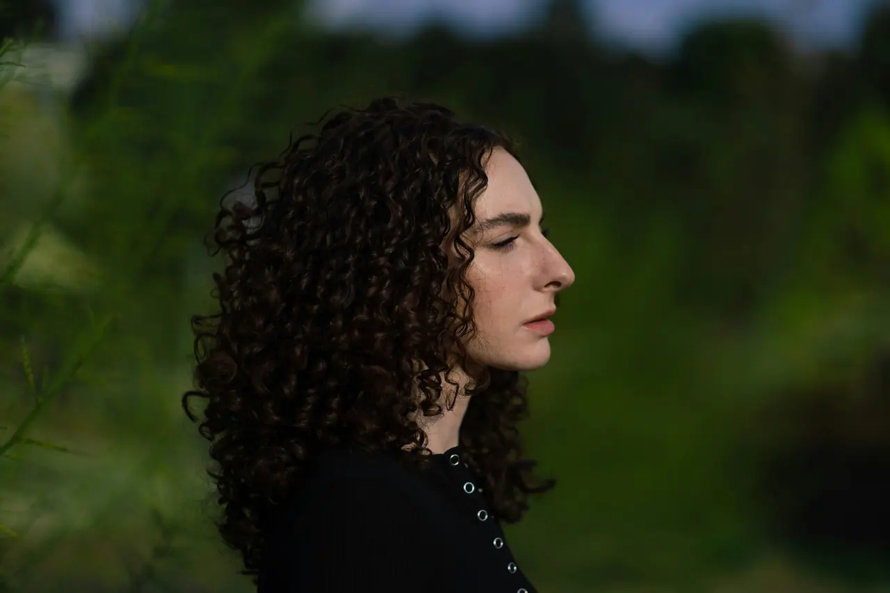 Portrait of a clinician in profile against greenery